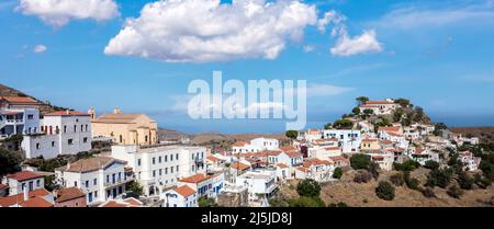 Kea island, Cyclades Greece. Ioulis town at the top of the hill, panorama aerial view. Tzia Chora cityscape, blue cloudy sky and calm sea background Stock Photo