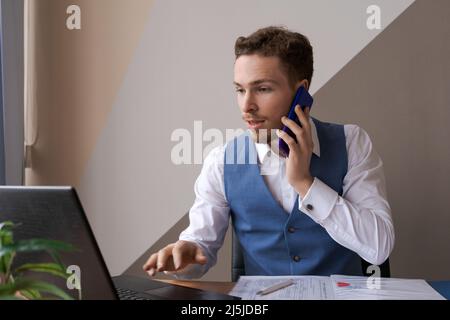 Portrait successful businessman with beard using smartphone and working on documents in office, success man in office interior with mobile phone and contract on desk. Busy caucasian worker Stock Photo