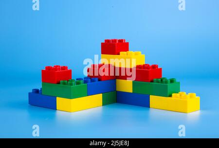 Plastic building blocks on blue background Stock Photo