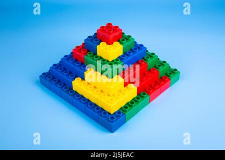 Plastic building blocks on blue background Stock Photo