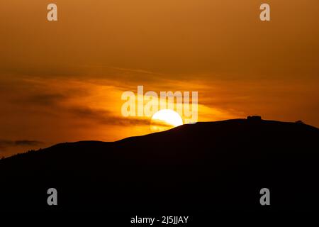 Sunset over the Jubilee Tower on the summit of Moel Famau, North Wales Stock Photo