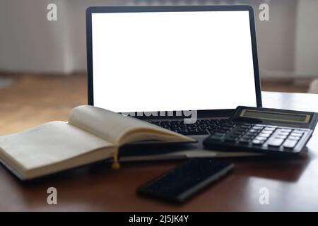 Workspace desk, calculator, Business image, Blank screen computer and supplies. laptop mock up screen view. work from home concept Stock Photo
