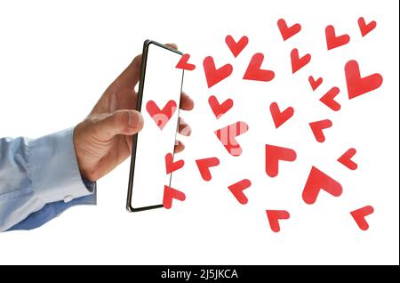 mobile phone holding on man hand sending red heart for lover in white background Stock Photo