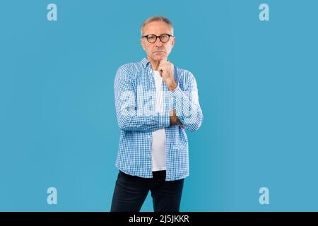 Portrait of pensive mature man looking at camera Stock Photo