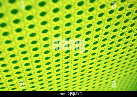 Neon lime colored abstract pattern with holes and lines. Digital and music textures and backdrops Stock Photo