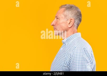 Serious mature man posing looking aside at studio Stock Photo