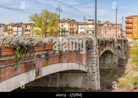 The middle bridge, ponte di mezzo,  over the Parma stream, Italy, on a sunny day Stock Photo