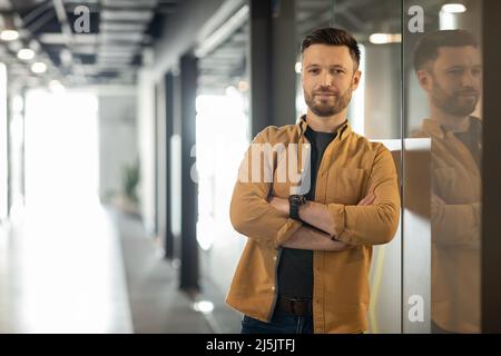 Confident Businessman Crossing Hands Posing Standing In Doorway In Office Stock Photo