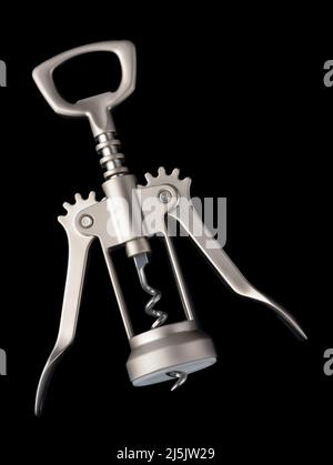 Top view of steel winged corkscrew bottle opener isolated on black Stock Photo