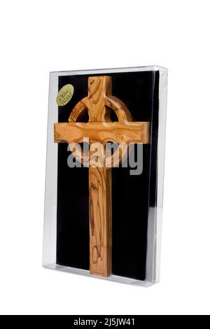 Wooden crucifix standing in box on white background Stock Photo