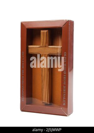 Wooden crucifix standing in box on white background Stock Photo