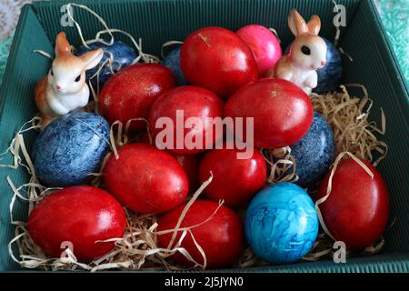 Beautiful Easter eggs lie in a basket. Stock Photo