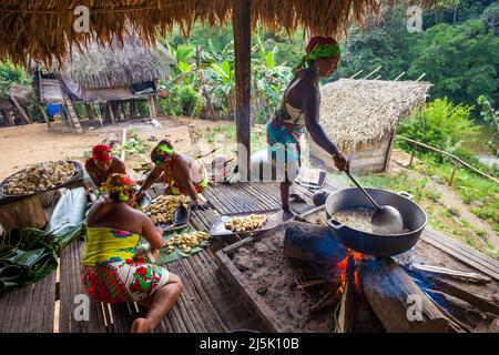 Embera puru indian woman are preparing and frying plantain in the Embera puru village, Republic of Panama, Central America. Stock Photo