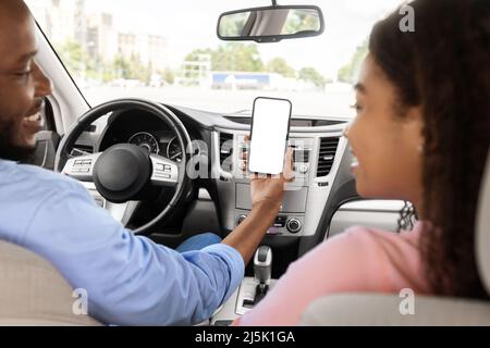 Happy African couple using showing smartphone with empty screen Stock Photo