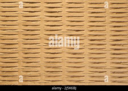 Perforated wrapping recycled brown paper. Corrugated grunge eco material with geometrical line pattern. Abstract background Stock Photo