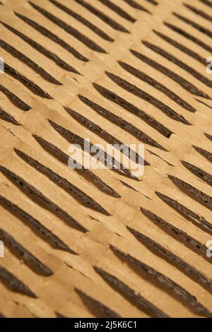 Perforated wrapping recycled brown paper. Corrugated grunge eco material with geometrical line pattern. Abstract background Stock Photo