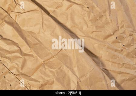 Wrapping paper crease. Wrinkled brown texture. Crumpled abstract background Stock Photo