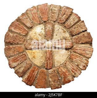 Close-up of an old Religious Cross made of bricks and stones, isolated on white background. Verona, Italy, Europe. Stock Photo