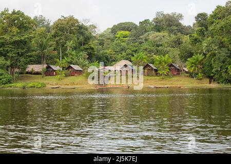 Eco-friendly Danpaati Lodge on the banks of Suriname River with a canoe moored, Upper Suriname, South America Stock Photo