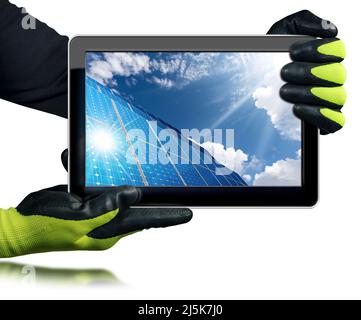 Engineer with protective work gloves showing a digital tablet computer with a group of solar panels inside the screen. Isolated on white background. Stock Photo