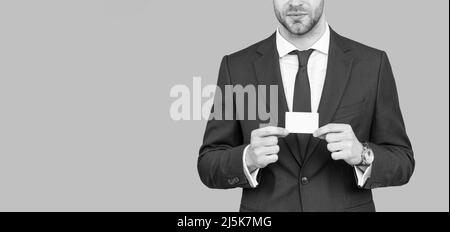 cropped businessman hold credit card with copy space on grey background, banking Stock Photo