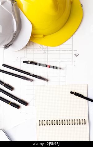 Mockup of architectural concept, Drawing tools and safety helmet on engineer drawing of blueprint. Stock Photo