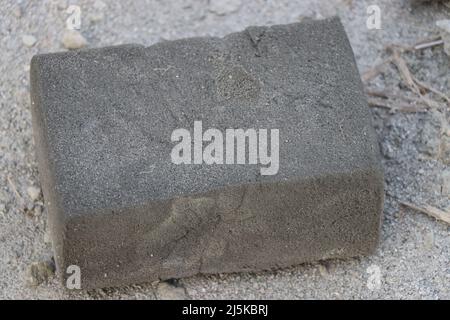 Used block of foam on the ground after work Stock Photo