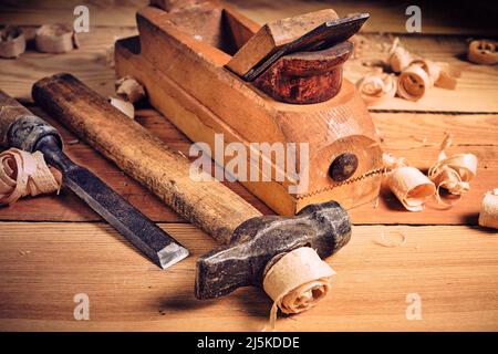 Set of tools for carpenters, hammer, chisel and plane on wooden background Stock Photo