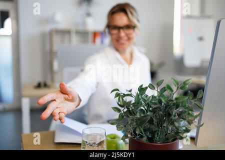 Close up view of businesswoman stretches out her hand for handshake. Friendly office worker Stock Photo