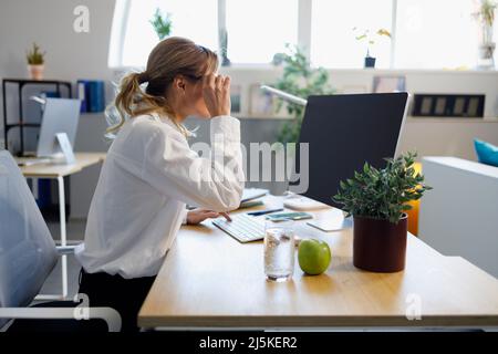 Adult business woman working on computer in the office Stock Photo