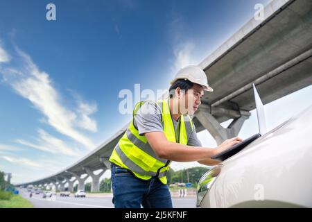 A Civil Engineers checking the expressway on road construction. Stock Photo