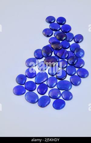 Blue glass bead patterns on white background April 2022 Stock Photo