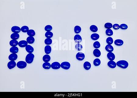 Blue glass bead patterns on white background April 2022 Stock Photo