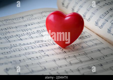 Red heart on a background of notes. The red heart is on the notes. Stock Photo