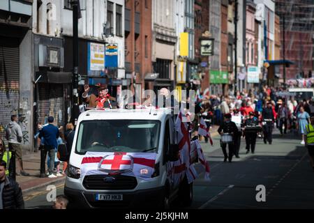 Manchester, UK. 24th Apr, 2022. The public line the streets as the annual St Georges Day parade passes through the city. Hundreds of people join in the annual celebration which marks the death of the patron Saint Of England. Credit: Andy Barton/Alamy Live News Stock Photo