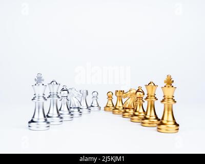 Set of luxury golden and silver chess pieces isolated on white background. The photo of rows of silver and gold chess, king, rook, bishop, queen, knig Stock Photo