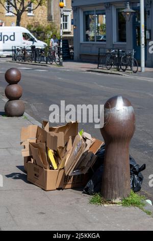 cardboard and recyclables out on bin day on the pavement in Peckham Stock Photo