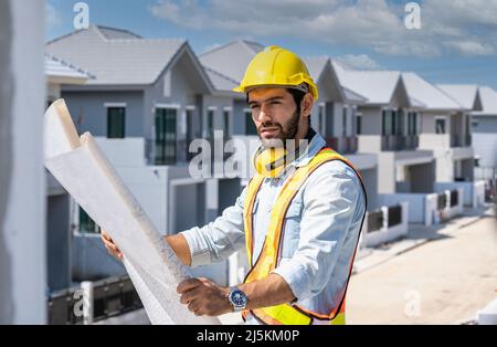 Engineer working on construction building site,Architects discussing project of building outdoors. Stock Photo