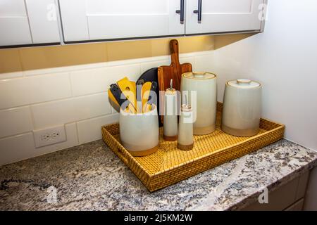 Wicker Basket Of Kitchen Containers On Counter Top Stock Photo
