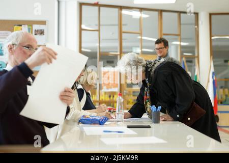 Ljubljana, Slovenia. 24th Apr, 2022. A voter registers at a polling station during the 2022 Slovenian parliamentary election in Ljubljana, Slovenia, April 24, 2022. About 1.7 million eligible voters in Slovenia cast their ballots on Sunday to elect the country's new Parliament. Credit: Zeljko Stevanic/Xinhua/Alamy Live News Stock Photo