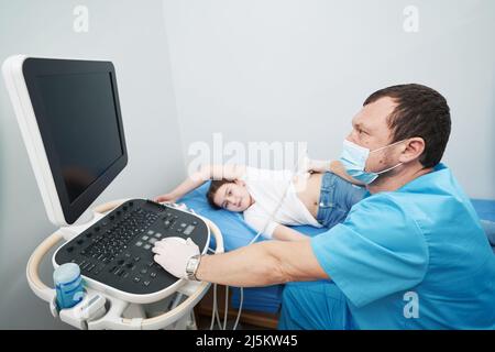 Caucasian medical worker conducting an examination of internal organs Stock Photo