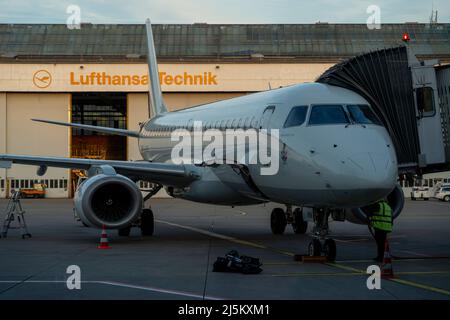 Workers inspecting a lufthansa plane in front of the lufthansa workshop Stock Photo