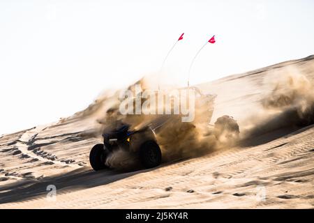 Doha, Qatar- April 22,2022: Off road buggy car in the sand dunes of the Qatari desert. Stock Photo