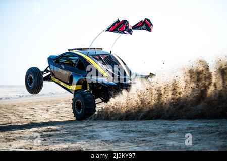 Doha, Qatar- April 22,2022: Off road buggy car in the sand dunes of the Qatari desert. Stock Photo