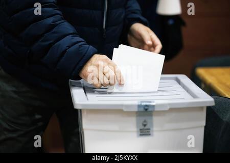 Kranj, Slovenia. 24th Apr, 2022. A voter casts his ballot during the 2022 Slovenian parliamentary elections in Kranj. A record turnout is expected, while polls suggest a tight race between Prime Minister Janez Jansa's Slovenian Democratic Party (SDS) and the Freedom Movement, a new party headed by Robert Golob. Credit: SOPA Images Limited/Alamy Live News Stock Photo