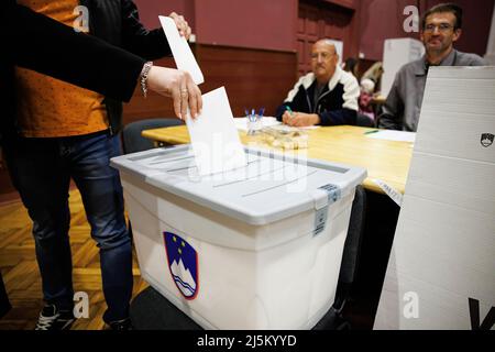 Kranj, Slovenia. 24th Apr, 2022. Voters cast their ballots during the 2022 Slovenian parliamentary elections in Kranj. A record turnout is expected, while polls suggest a tight race between Prime Minister Janez Jansa's Slovenian Democratic Party (SDS) and the Freedom Movement, a new party headed by Robert Golob. Credit: SOPA Images Limited/Alamy Live News Stock Photo