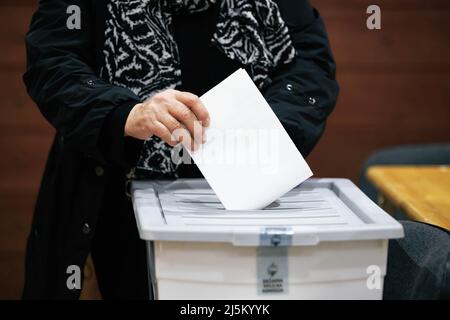 Kranj, Slovenia. 24th Apr, 2022. A voter casts her ballot during the 2022 Slovenian parliamentary elections in Kranj. A record turnout is expected, while polls suggest a tight race between Prime Minister Janez Jansa's Slovenian Democratic Party (SDS) and the Freedom Movement, a new party headed by Robert Golob. Credit: SOPA Images Limited/Alamy Live News Stock Photo