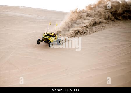 Doha, Qatar- April 22,2022: Off road buggy car in the sand dunes of the Qatari desert. Stock Photo