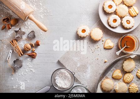 Making and baking cut-out sugar cookies of all shapes and sizes. Holiday, celebration and cooking concept. Stock Photo