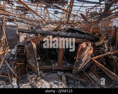 Borodyanka, Ukraine - April 2022: Burnt and destroyed military equipment on streets of village as a result of an attack by Russian invaders. Details of a Russian infantry fighting vehicle (BMP). Stock Photo